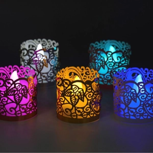 Five colored laser-cut paper hollow LED candle holders with intricate leaf patterns