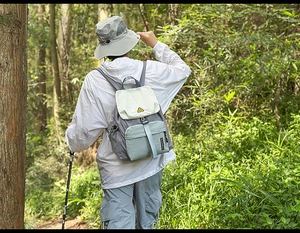Outdoor color-block backpack worn with hiking gear and professional trekking poles