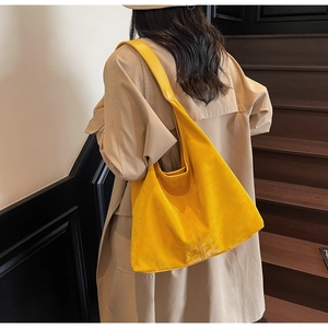 Macro shot of a bright yellow large-capacity hobo tote bag in soft waxed PU leather