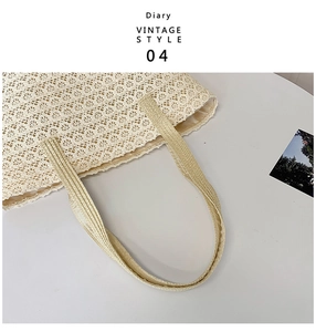 Detailed close-up of a woven cream tote bag with vintage lace patterns and silky lining
