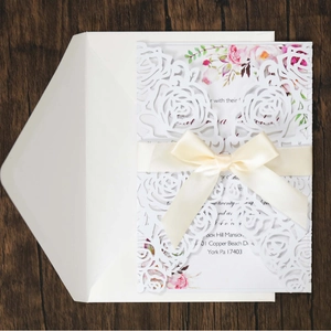 Laser cut pearl paper wedding invitation set with rose pattern and beige satin ribbon