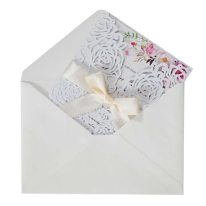 Laser cut rose wedding invitation with cream silk bow, floral inner page and white envelope