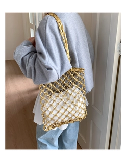 Close-up of golden mesh shoulder bag with a white drawstring inner pouch for summer