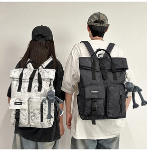 Detail of marble pattern canvas backpack with flip cover and frog plush pendant