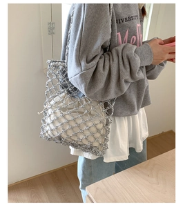 Silver metallic woven hollow tote bag with a white drawstring inner pouch detail