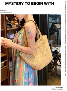 Detail showing the intricate hollow weave texture of the beige straw shoulder tote bag