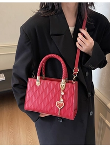 Red quilted wedding tote bag with gold heart pendant and woven handle for brides