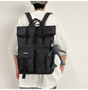 Detailed view of waterproof utility backpack with marble texture and frog charm accessory
