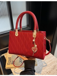 Deep red quilted wedding tote bag with braided handles and heart shaped pendant