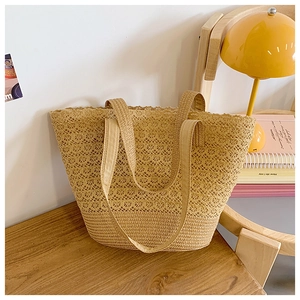 Close-up of hollow woven pattern and straw texture on a large khaki tote bag