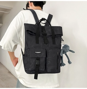Detail of marble pattern backpack with functional side pockets and plush frog pendant