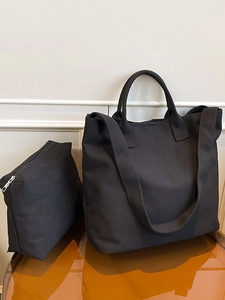 Minimalist black canvas tote bag set with matching zipper pouch and wide shoulder straps