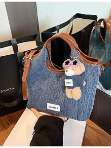 Large blue denim bucket bag with brown leather trim and cute bear keychain charm