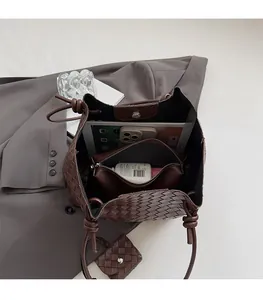 Top view of brown woven tote bag with large capacity and matching internal zipper pouch