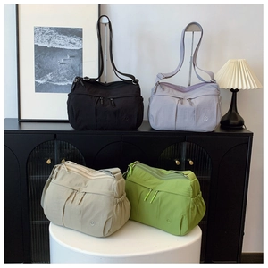 Detailed arrangement of four stylish nylon crossbody bags in assorted soft colors