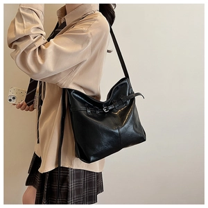 Close-up of a black leather hobo bag with a silver buckle and large capacity