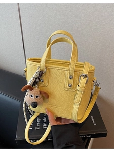 Minimalist bright yellow litchi pattern handbag with silver rivets and puppy pendant