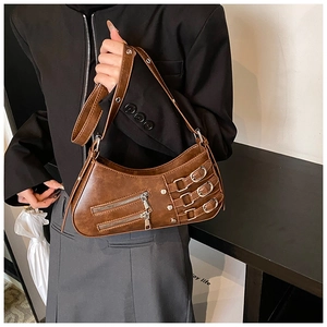 Detail of retro brown pleated bag with metal buckle straps and double zipper design