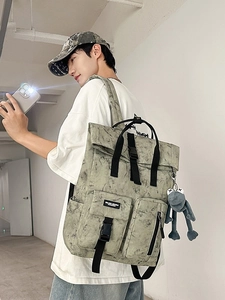 Gray-green marble wash backpack with roll-top closure and grey frog plush charm