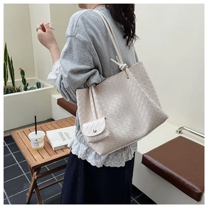 Detail of large woven leather tote bag with matching coin purse and woven texture