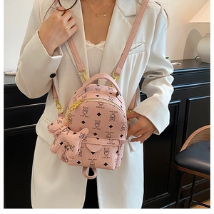 Detail of pink Teddy Bear backpack showing gold hardware and cute bear pendant