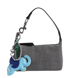 Large gray canvas hobo bag with leather strap and blue elephant charm accessory