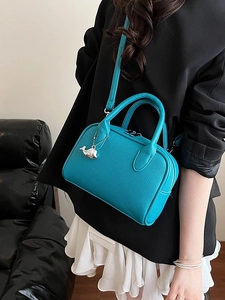 Litchi pattern leather bowling bag in turquoise green with silver whale pendant