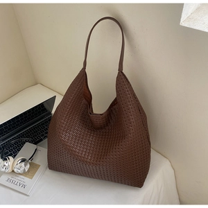 Macro shot of large brown woven hobo tote bag with soft texture for daily commute