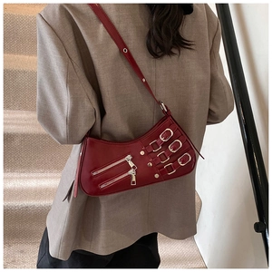 Detail view of dark red leather biker bag featuring silver buckles and zipper accents