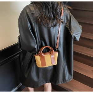 Classic canvas and brown leather mini tote bag shown being worn on long shoulder strap