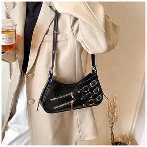 Detail of black glossy handbag with silver metal buckles and zippers in a chic y2k style