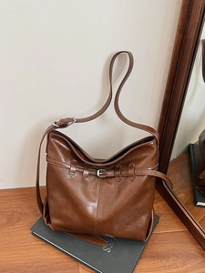 Vintage brown leather tote bag with decorative buckle and spacious single shoulder design