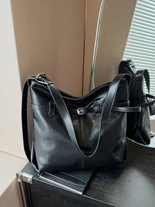 Classic black faux leather hobo shoulder bag with adjustable strap and metal buckle detail