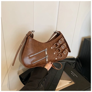 Detail of brown vintage leather hobo bag with silver buckles and parallel zippers