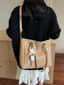 Khaki woven tote bag with adjustable shoulder strap and cute bear charm pendant