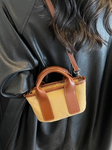 Khaki canvas mini tote bag with brown faux leather trim and detachable shoulder strap