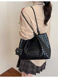 Large black woven tote bag with matching pouch and slim leather straps for women