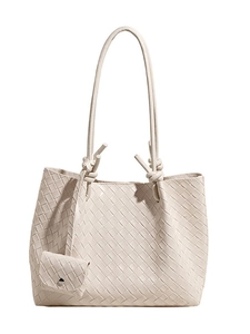 Quilted cream tote bag with woven texture, shoulder straps, and small coin purse attachment