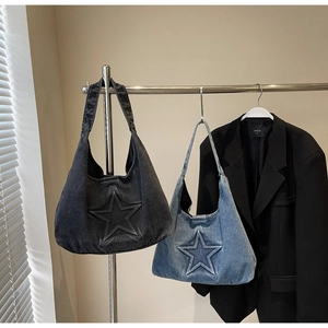 Close-up of hobo denim tote bags with embossed star stitching in grey and light blue