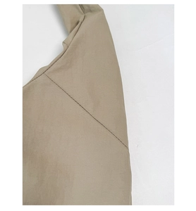 Detail shot of khaki tote bag nylon fabric with high-quality stitching and texture