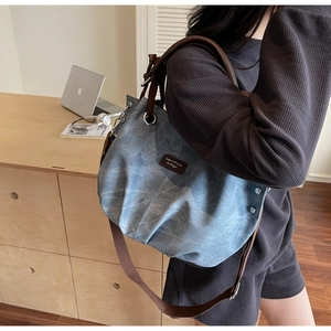 Detailed view of vintage large tote bag with pleated canvas and leather straps