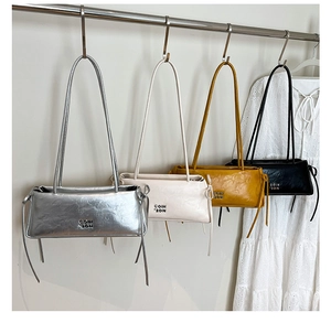 Détail de sacs rétro en cuir ciré disponibles en argent, crème, jaune et noir chic