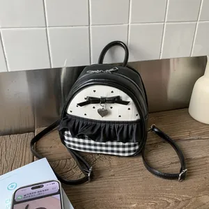 Detail of a mini Lolita style backpack with heart prints, bow accents, and lace trim
