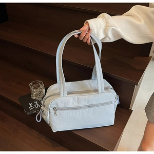 Close-up of light blue wrinkled texture canvas tote with silver double zipper detail