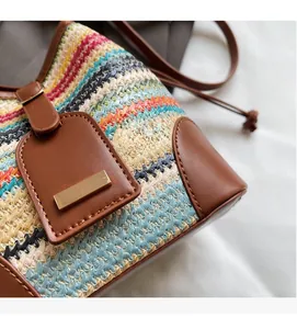 Detail showing artisanal woven fabric texture with contrast stitching and leather accents