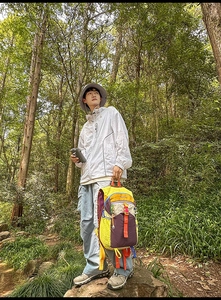 Voyageur en plein air avec sac à dos patchwork grande capacité et veste solaire