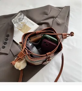 Detail showing internal capacity of colorful woven bucket bag with leather drawstring