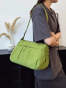 Minimalist grass green crossbody bag with multi-zipper pockets and adjustable strap
