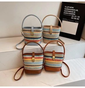 Detailed close-up of woven bucket bags in various striped colors with leather straps