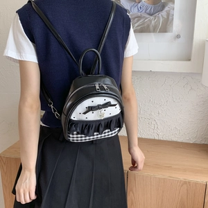 Mini backpack for women featuring black and white plaid design with cute bow and heart pendant